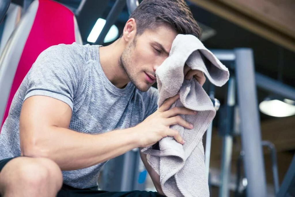 wholesale gym towels portrait handsome man sitting on bench gym towel ss Why You Need Gym Towels